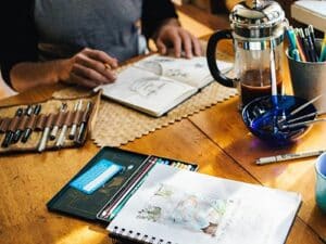 sketching and watercolour notebook on cafe table