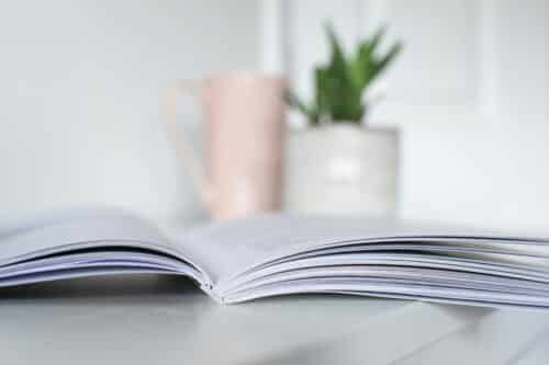 Booklet on table with vase