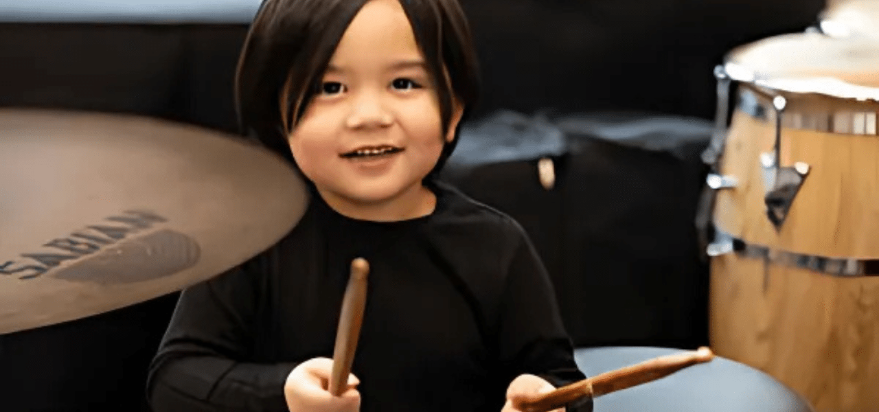 Small child holding drumsticks