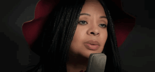 Woman singing into microphone