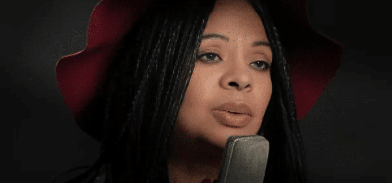 Woman singing into microphone