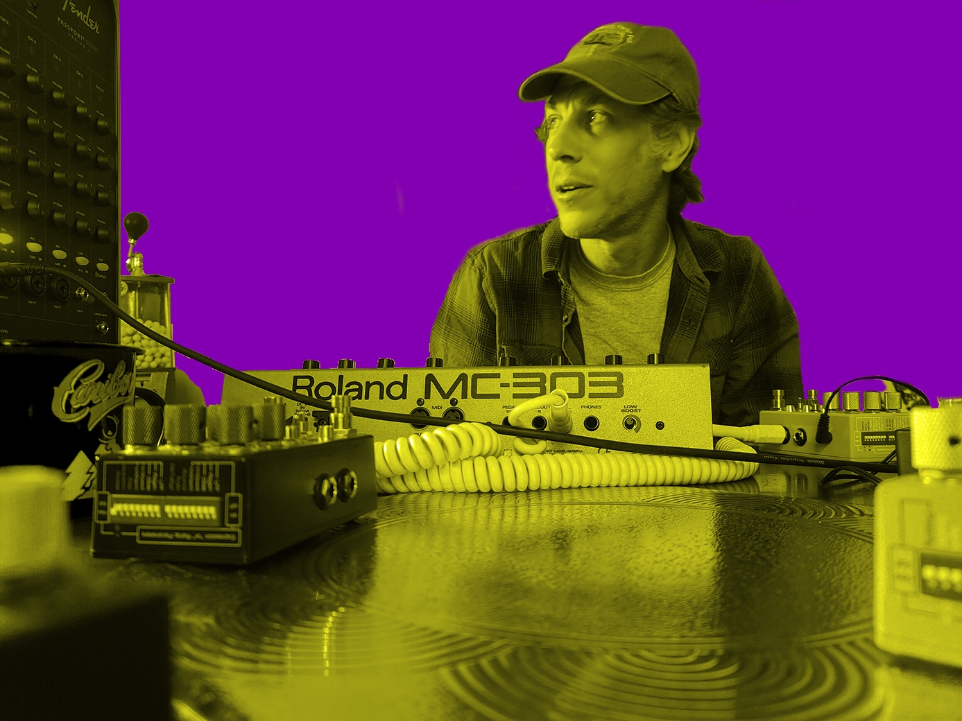 Man sitting behind Roland synth and pedals